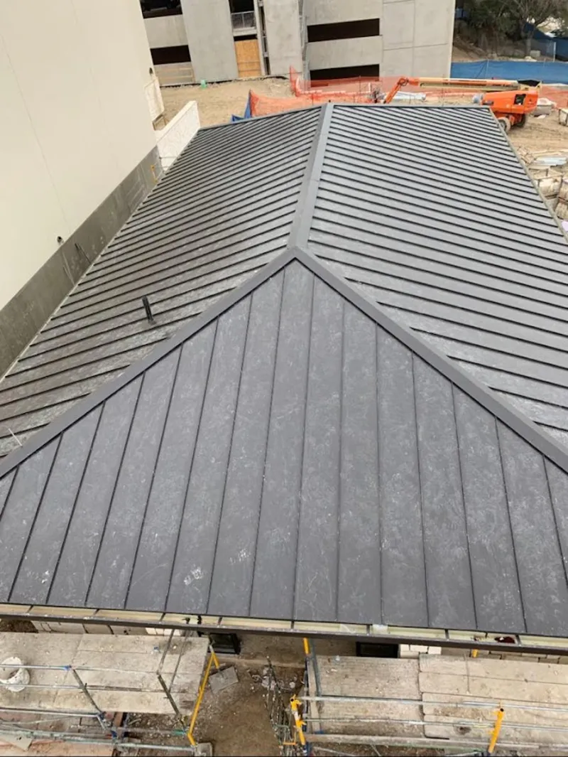 Commercial metal roof construction with crane equipment in White Hall